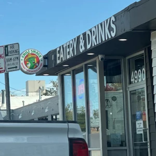 Exterior of Chili Shack restaurant with its logo, "Eatery & Drinks" sign, and address 4990.