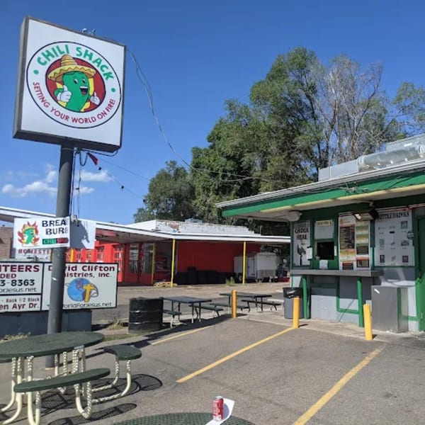 The Chili Shack restaurant exterior with a sign featuring a smiling chili pepper in a sombrero.