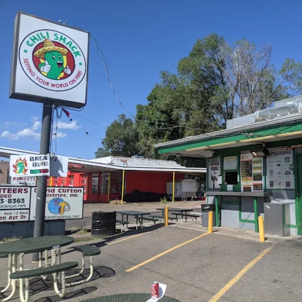 The Chili Shack restaurant exterior with a sign featuring a smiling chili pepper in a sombrero.